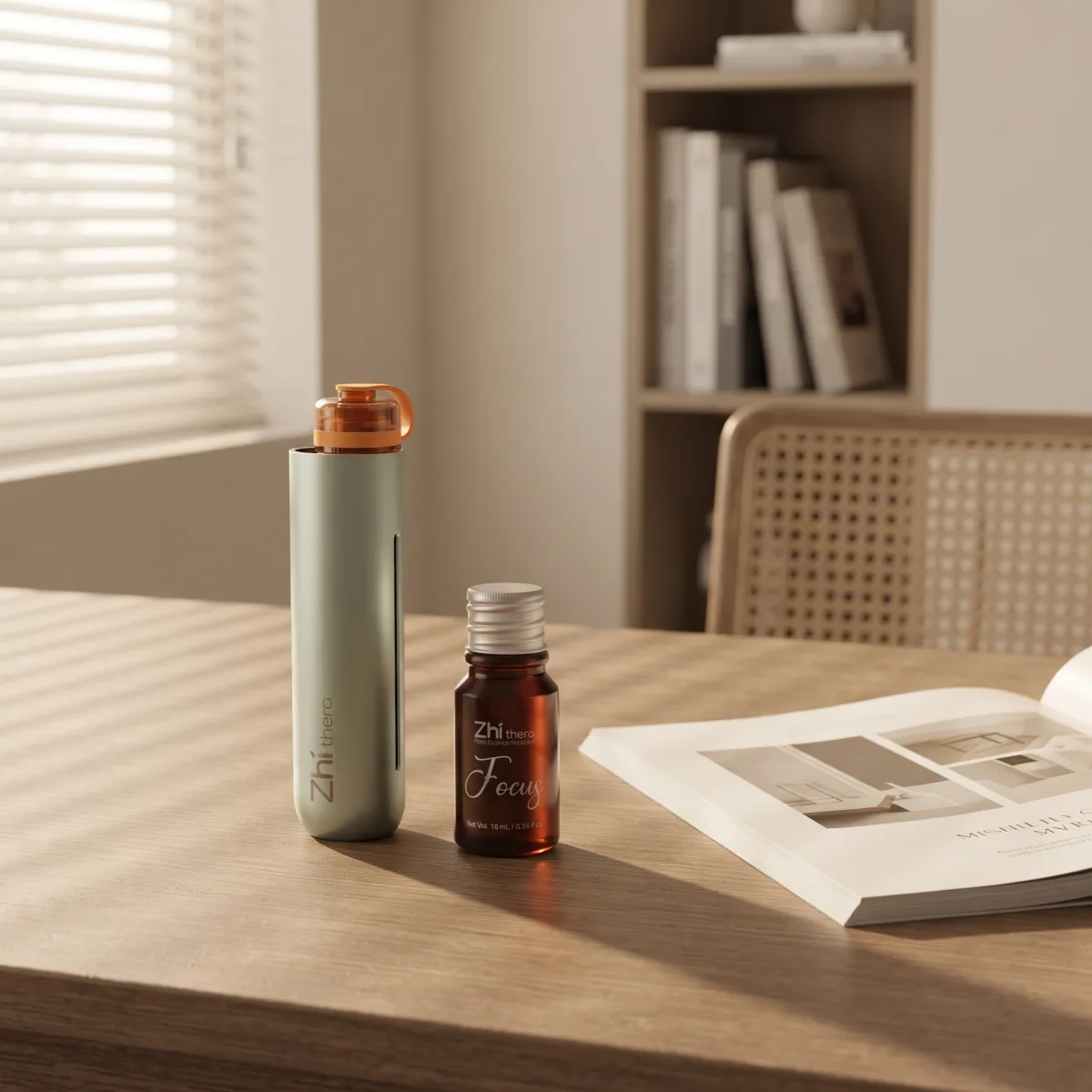 Sage Zhithera D1 Mini diffuser on a desk beside a 10 ml essential oil labeled "Focus"