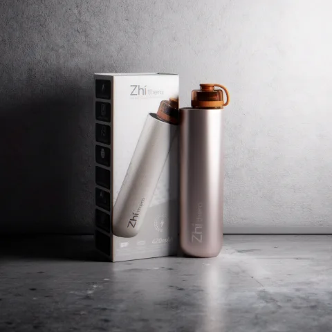 Silver and rose Zhithera D1 Mini diffusers beside their retail box on concrete