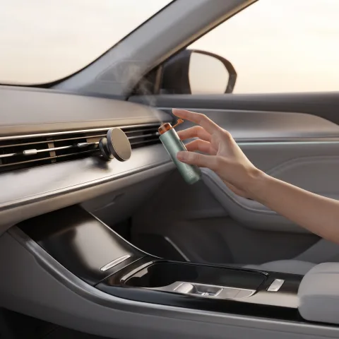 Hand placing the Zhithera D1 Mini waterless car diffuser on a magnetic vent mount